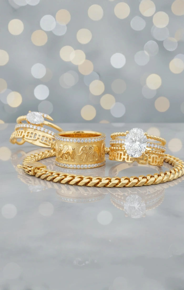 Set of gold rings with elephant design on a gray background with bokeh lights